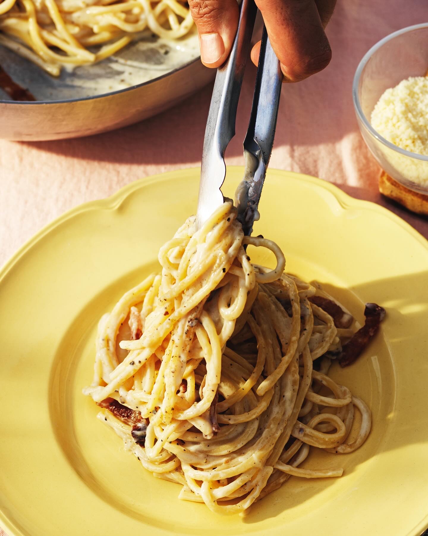 Spaghetti carbonara on a yellow plate